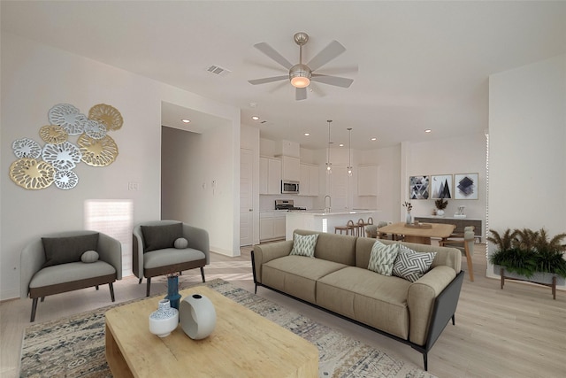 8918 Grovner Pl, Houston, TX 77055 - living room featuring light wood finished floors, ceiling fan, recessed lighting, and baseboards