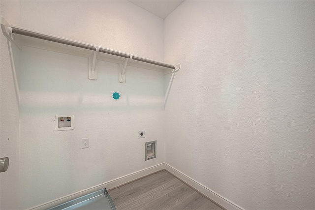 8918 Grovner Pl, Houston, TX 77055 - washroom featuring washer hookup, electric dryer hookup, wood finished floors, and baseboards