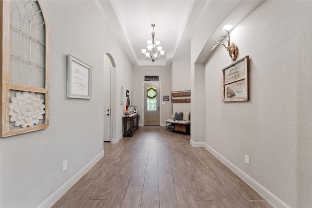 28026 Chuckwagon Trl, Magnolia, TX 77355 - entrance foyer featuring a chandelier, wood finished floors, crown molding, and baseboards