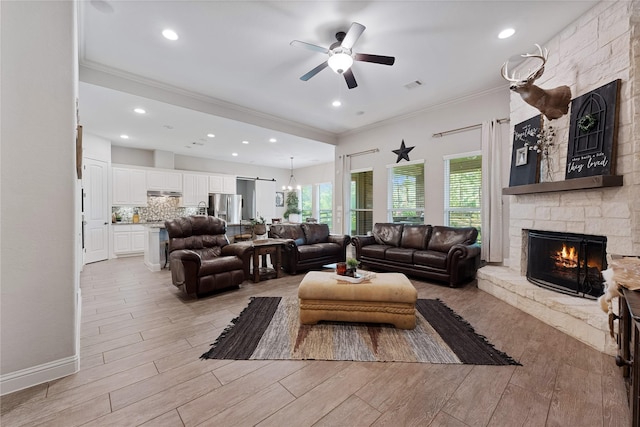 28026 Chuckwagon Trl, Magnolia, TX 77355 - living room featuring crown molding, a fireplace, a ceiling fan, light wood-type flooring, and recessed lighting