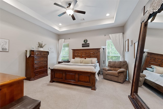 28026 Chuckwagon Trl, Magnolia, TX 77355 - bedroom featuring light carpet, multiple windows, recessed lighting, ceiling fan, and a raised ceiling