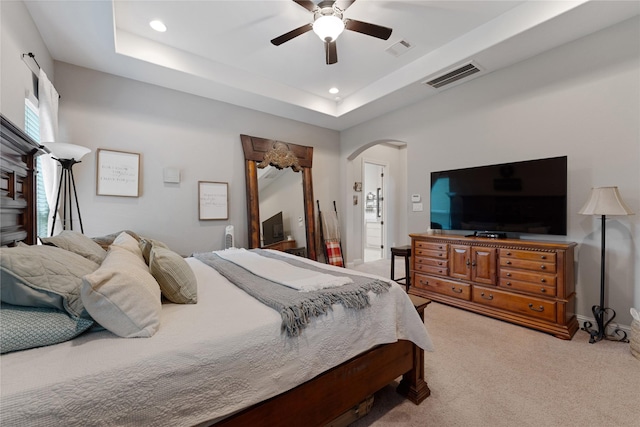 28026 Chuckwagon Trl, Magnolia, TX 77355 - bedroom with arched walkways, light carpet, recessed lighting, a ceiling fan, and a tray ceiling
