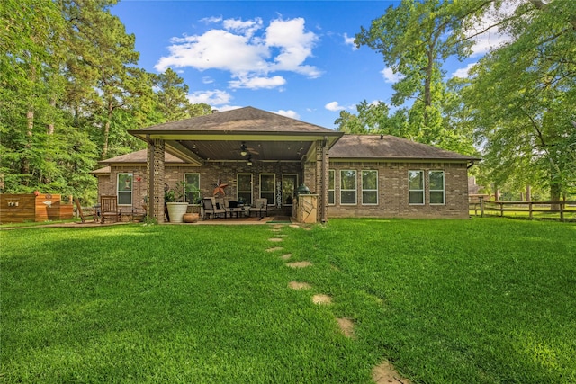 28026 Chuckwagon Trl, Magnolia, TX 77355 - rear view of house featuring ceiling fan, a patio, brick siding, and a shingled roof