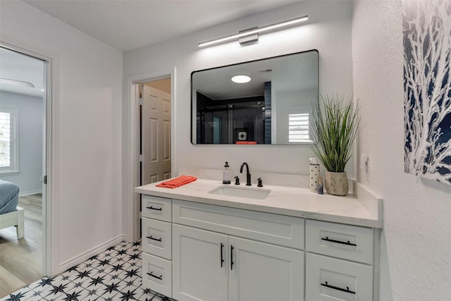 1427 Bamboo Dr, Tiki Island, TX 77554 - full bath with tile patterned floors, vanity, a shower with shower door, and baseboards