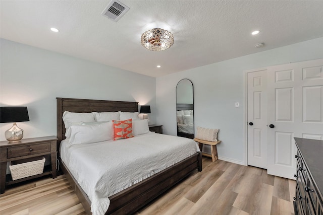 1427 Bamboo Dr, Tiki Island, TX 77554 - bedroom with light wood-style floors, recessed lighting, baseboards, and a textured ceiling