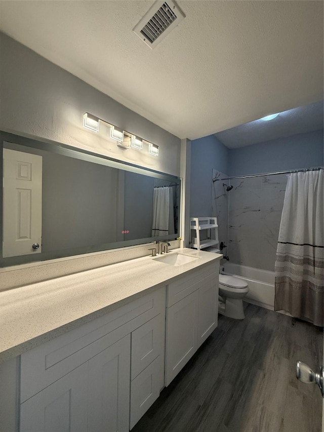 8149 Sands Point Dr Unit 113, Houston, TX 77036 - full bath with vanity, wood finished floors, toilet, shower / bath combo with shower curtain, and a textured ceiling