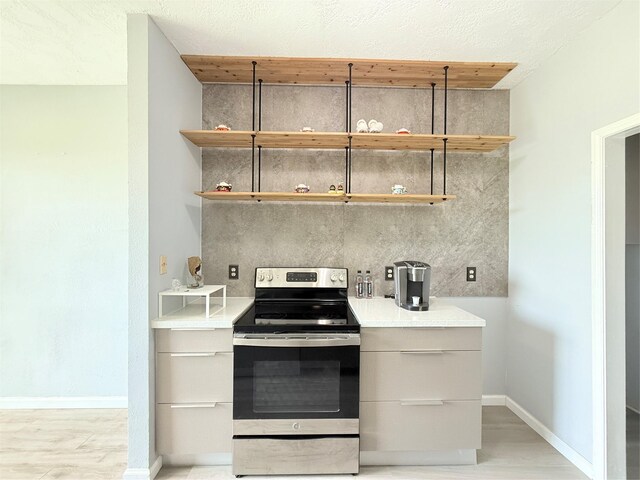 8149 Sands Point Dr Unit 113, Houston, TX 77036 - kitchen with stainless steel electric range oven, modern cabinets, light wood-type flooring, and open shelves