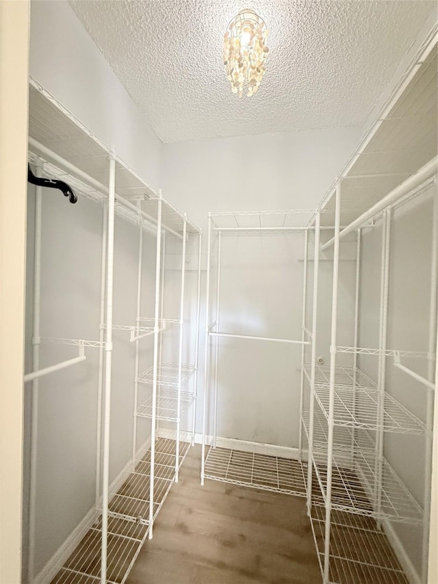 8149 Sands Point Dr Unit 113, Houston, TX 77036 - spacious closet with wood finished floors and a chandelier