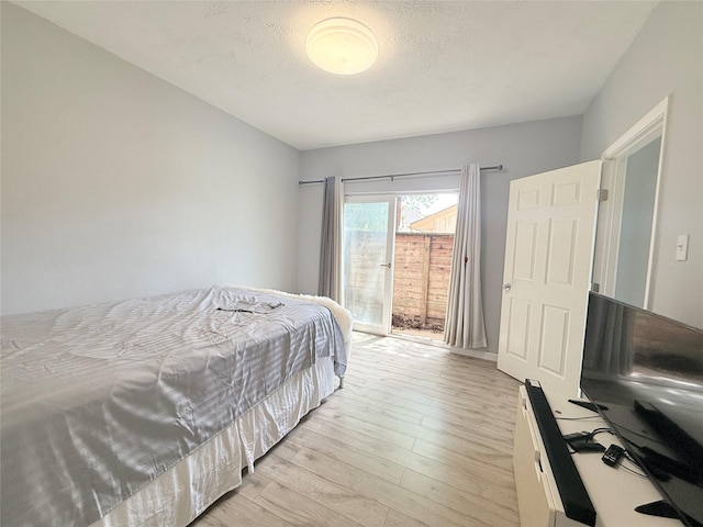 8149 Sands Point Dr Unit 113, Houston, TX 77036 - bedroom featuring light wood-type flooring and access to exterior