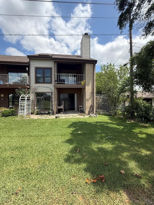 8149 Sands Point Dr Unit 113, Houston, TX 77036 - rear view of property featuring a balcony and a chimney