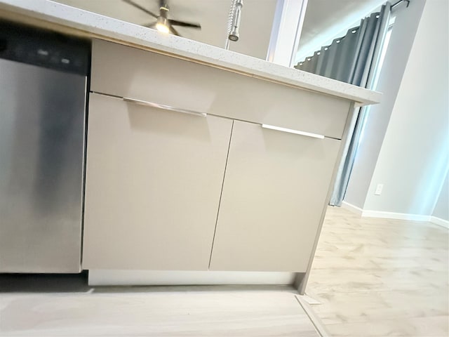 8149 Sands Point Dr Unit 113, Houston, TX 77036 - kitchen view of dishwasher, light stone counters, baseboards, and modern cabinets