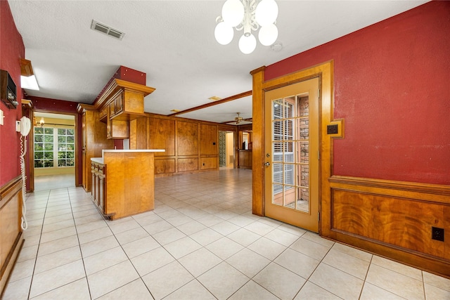 4923 Bradstone Ct, Houston, TX 77084 - kitchen featuring a chandelier, brown cabinets, ceiling fan, and light tile patterned floors