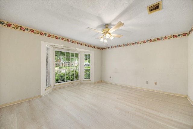 4923 Bradstone Ct, Houston, TX 77084 - unfurnished room featuring light wood-type flooring, a ceiling fan, baseboards, and a textured ceiling