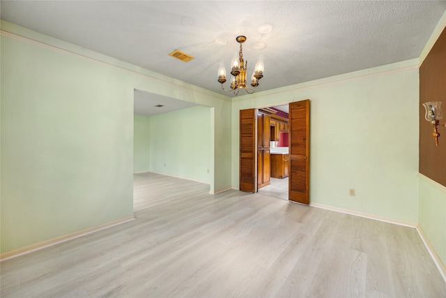 4923 Bradstone Ct, Houston, TX 77084 - empty room featuring a chandelier, light wood-type flooring, baseboards, and crown molding