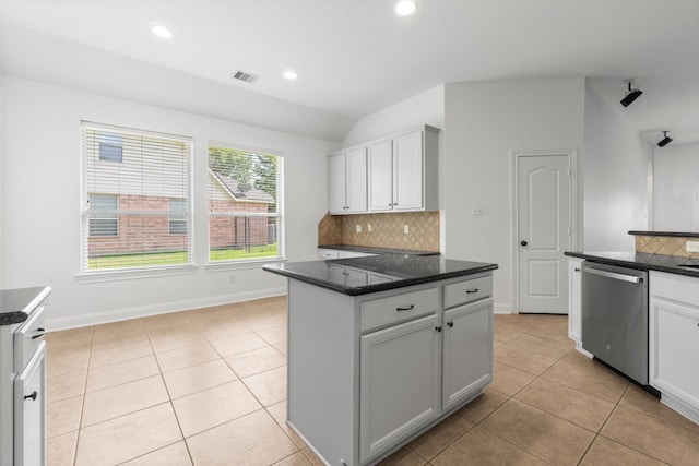 7 Fraiser Fir Pl, Spring, TX 77389 - kitchen with stainless steel dishwasher, vaulted ceiling, decorative backsplash, light tile patterned flooring, and recessed lighting
