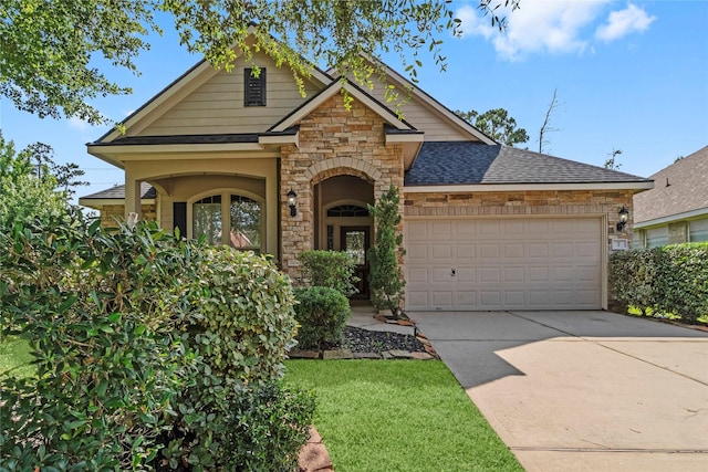 7 Fraiser Fir Pl, Spring, TX 77389 - craftsman-style house featuring stone siding, a garage, a shingled roof, and driveway