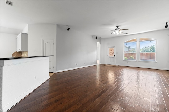 7 Fraiser Fir Pl, Spring, TX 77389 - unfurnished living room with ceiling fan, dark wood-style floors, arched walkways, and baseboards