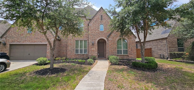 11438 Sandhaven Dr, Richmond, TX 77407 - view of front of house featuring brick siding, a garage, and driveway