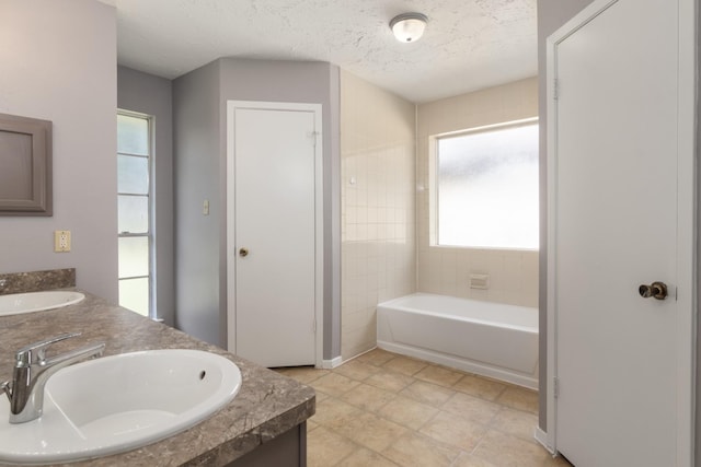 13402 Piney Oaks Dr, Houston, TX 77065 - full bath featuring a garden tub, double vanity, and a textured ceiling
