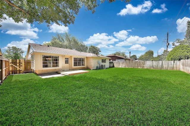 9814 Appleridge Dr, Houston, TX 77070 - back of property with brick siding, a patio area, roof with shingles, a gate, and central AC