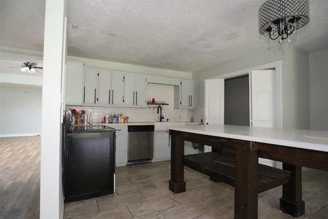 5952 Moonstone St, Port Arthur, TX 77640 - kitchen featuring stainless steel dishwasher, a sink, backsplash, a textured ceiling, and light countertops