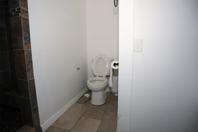 5952 Moonstone St, Port Arthur, TX 77640 - full bathroom featuring tile patterned flooring, toilet, a tile shower, and baseboards