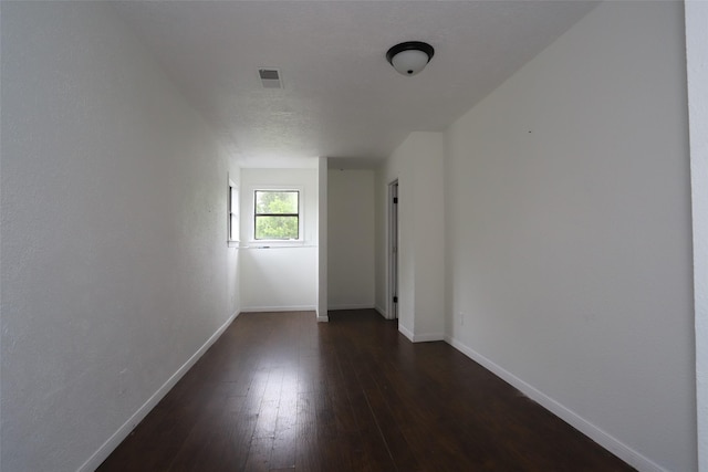 5952 Moonstone St, Port Arthur, TX 77640 - unfurnished room with baseboards and dark wood-style flooring