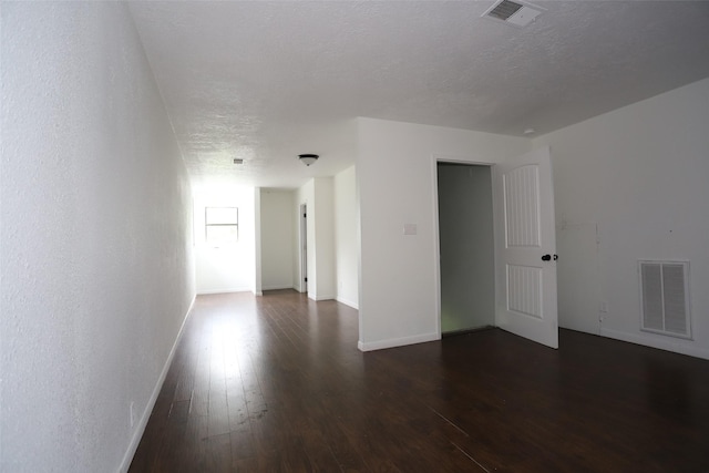 5952 Moonstone St, Port Arthur, TX 77640 - unfurnished room with dark wood-type flooring, baseboards, and a textured ceiling