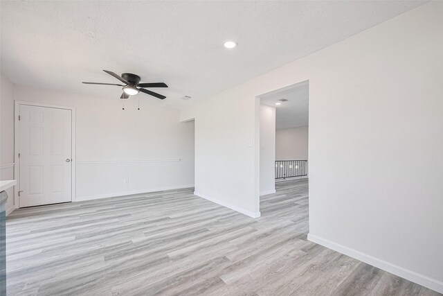 413 E Castle Harbour Dr W, Friendswood, TX 77546 - empty room featuring a ceiling fan, light wood-style floors, baseboards, a textured ceiling, and recessed lighting