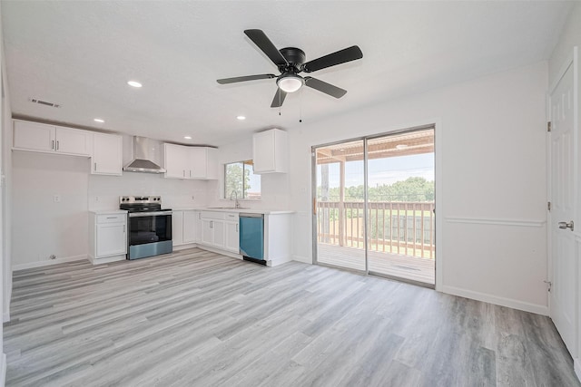 413 E Castle Harbour Dr W, Friendswood, TX 77546 - kitchen with stainless steel electric range, dishwasher, wall chimney range hood, light wood finished floors, and white cabinetry