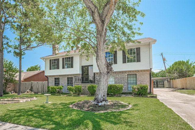 413 E Castle Harbour Dr W, Friendswood, TX 77546 - bi-level home with brick siding, a chimney, concrete driveway, and a carport