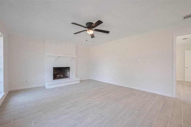413 E Castle Harbour Dr W, Friendswood, TX 77546 - unfurnished living room featuring ceiling fan, crown molding, light wood-style flooring, baseboards, and a brick fireplace