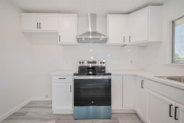413 E Castle Harbour Dr W, Friendswood, TX 77546 - kitchen featuring stainless steel range with electric stovetop, wall chimney range hood, decorative backsplash, white cabinets, and a textured ceiling