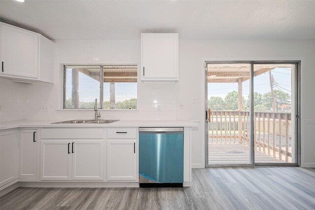 413 E Castle Harbour Dr W, Friendswood, TX 77546 - kitchen featuring dishwasher, a sink, light wood-style flooring, and decorative backsplash