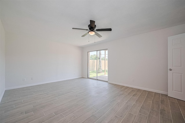 413 E Castle Harbour Dr W, Friendswood, TX 77546 - spare room featuring light wood-type flooring, a ceiling fan, and baseboards