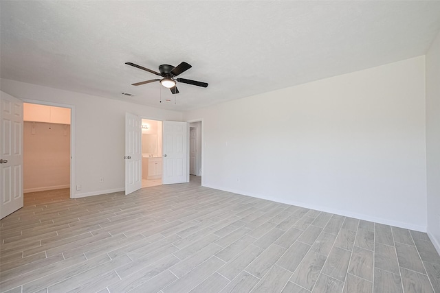 413 E Castle Harbour Dr W, Friendswood, TX 77546 - unfurnished bedroom featuring light wood-type flooring, baseboards, and a spacious closet