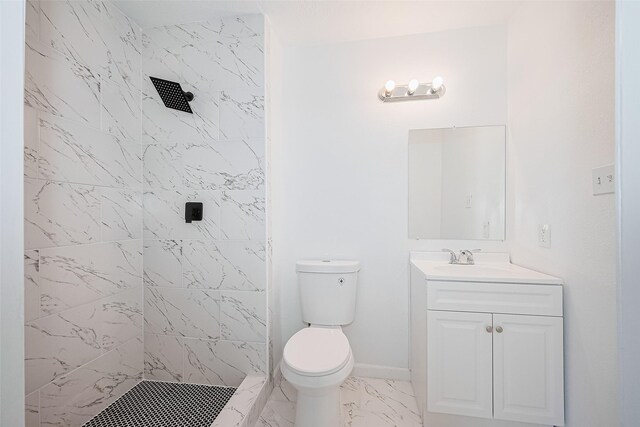 413 E Castle Harbour Dr W, Friendswood, TX 77546 - bathroom featuring a tile shower, marble look tile flooring, vanity, toilet, and baseboards