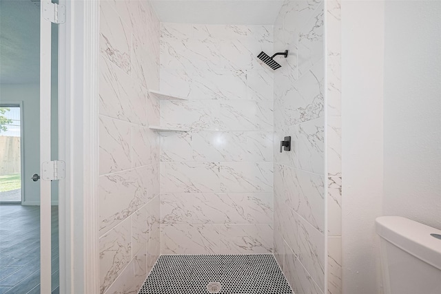 413 E Castle Harbour Dr W, Friendswood, TX 77546 - bathroom with tiled shower, toilet, and wood finished floors