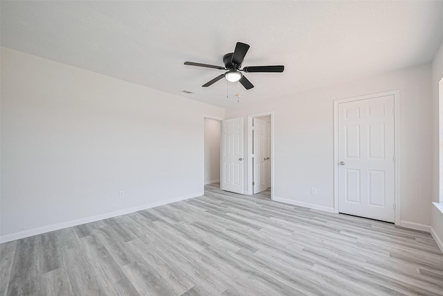 413 E Castle Harbour Dr W, Friendswood, TX 77546 - unfurnished bedroom with light wood-style flooring, baseboards, and a ceiling fan