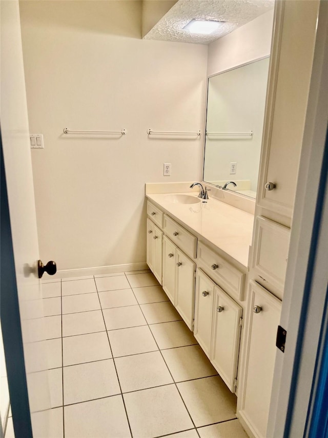 6523 Coral Ridge Rd, Houston, TX 77069 - bathroom with tile patterned flooring, vanity, a textured ceiling, and baseboards