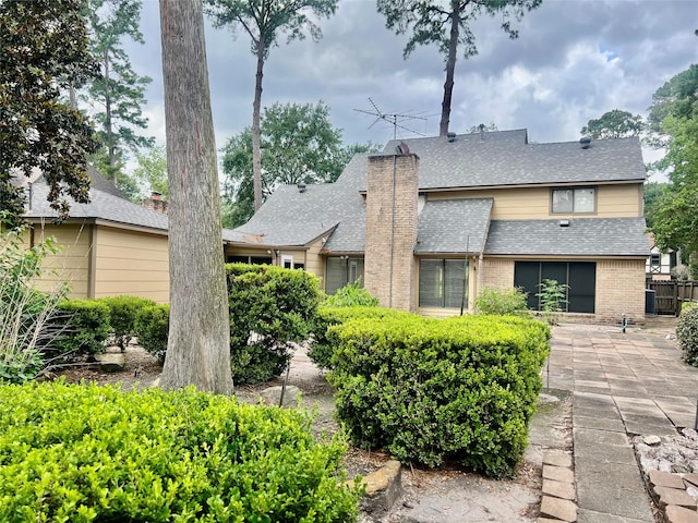 6523 Coral Ridge Rd, Houston, TX 77069 - back of house featuring a shingled roof, a patio, and brick siding