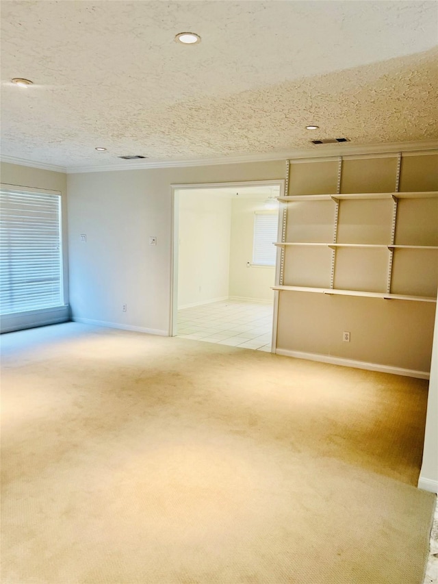 6523 Coral Ridge Rd, Houston, TX 77069 - empty room featuring ornamental molding, light carpet, baseboards, and a textured ceiling