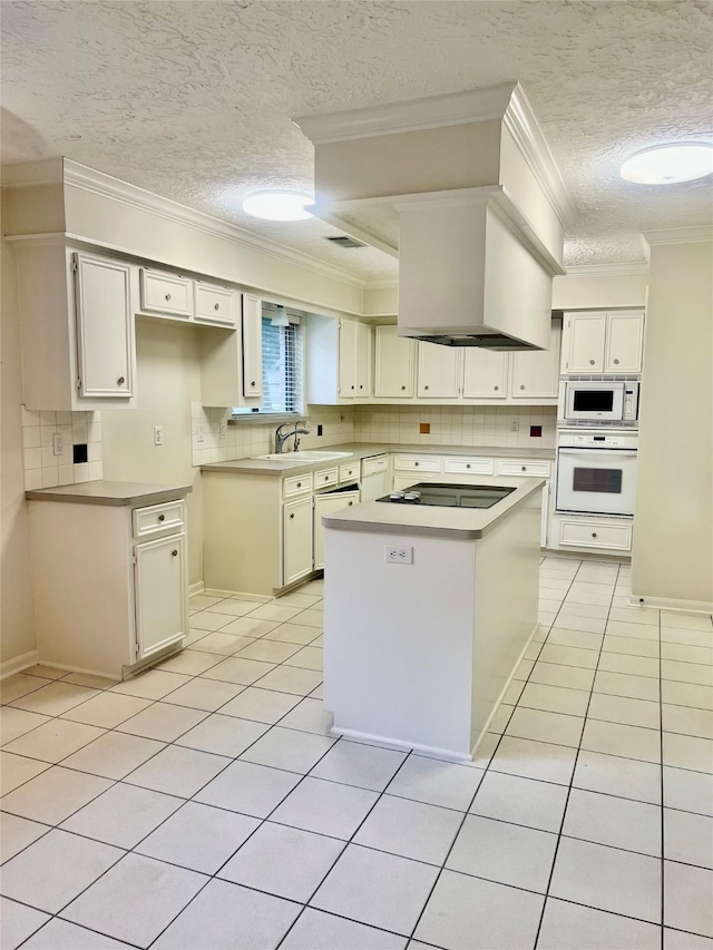 6523 Coral Ridge Rd, Houston, TX 77069 - kitchen with white appliances, a textured ceiling, a sink, ornamental molding, and a kitchen island