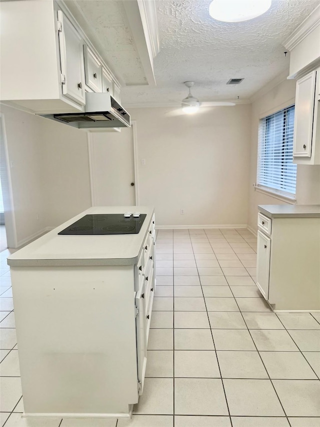6523 Coral Ridge Rd, Houston, TX 77069 - kitchen with light tile patterned floors, black electric stovetop, custom exhaust hood, light countertops, and a textured ceiling