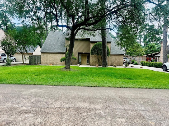 6523 Coral Ridge Rd, Houston, TX 77069 - mid-century home featuring brick siding, a shingled roof, and a front lawn