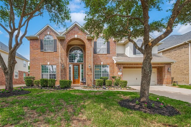 14727 Bronze Finch Dr, Cypress, TX 77433 - traditional-style home featuring driveway, brick siding, and a front lawn