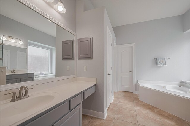 14727 Bronze Finch Dr, Cypress, TX 77433 - full bathroom featuring a bath, vanity, tile patterned flooring, and baseboards