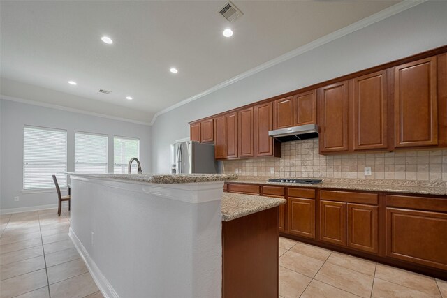 14727 Bronze Finch Dr, Cypress, TX 77433 - kitchen featuring light tile patterned floors, crown molding, an island with sink, decorative backsplash, and recessed lighting