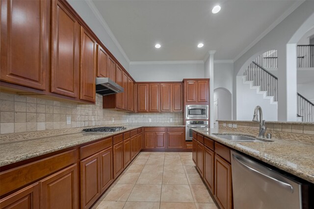 14727 Bronze Finch Dr, Cypress, TX 77433 - kitchen with appliances with stainless steel finishes, a sink, extractor fan, crown molding, and arched walkways
