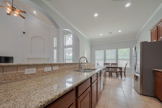 14727 Bronze Finch Dr, Cypress, TX 77433 - kitchen with appliances with stainless steel finishes, a sink, ornamental molding, light stone countertops, and a ceiling fan